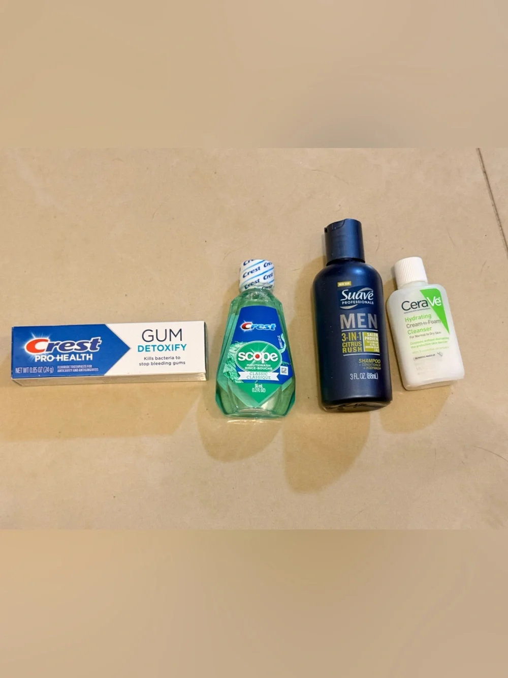 Travel size toothpaste, mouthwash, cerave hydrating cream and suave shampoo